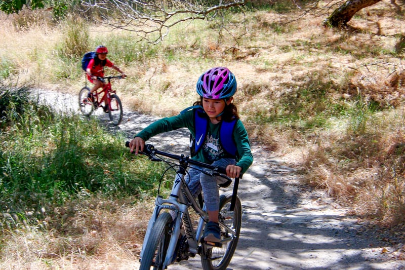 kid biking on trail