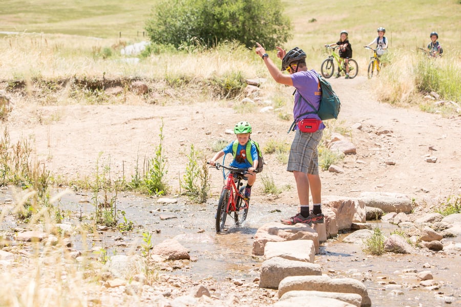 kids biking at outdoor adventure summer camp