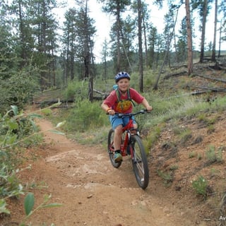 Boy biking down trail.jpg