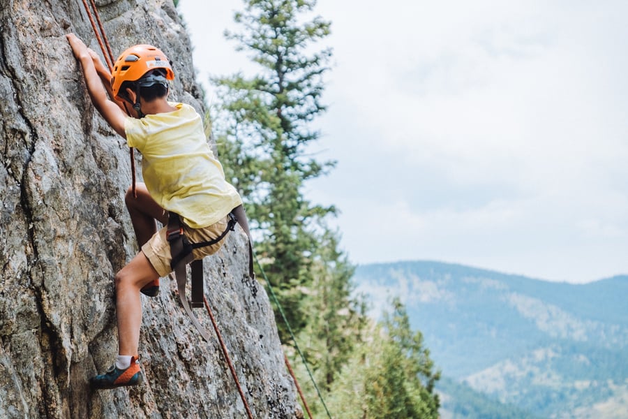 kid rock climbing outdoors