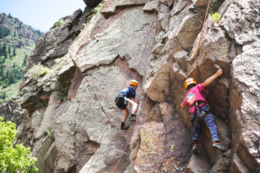 kids rock climbing at camp