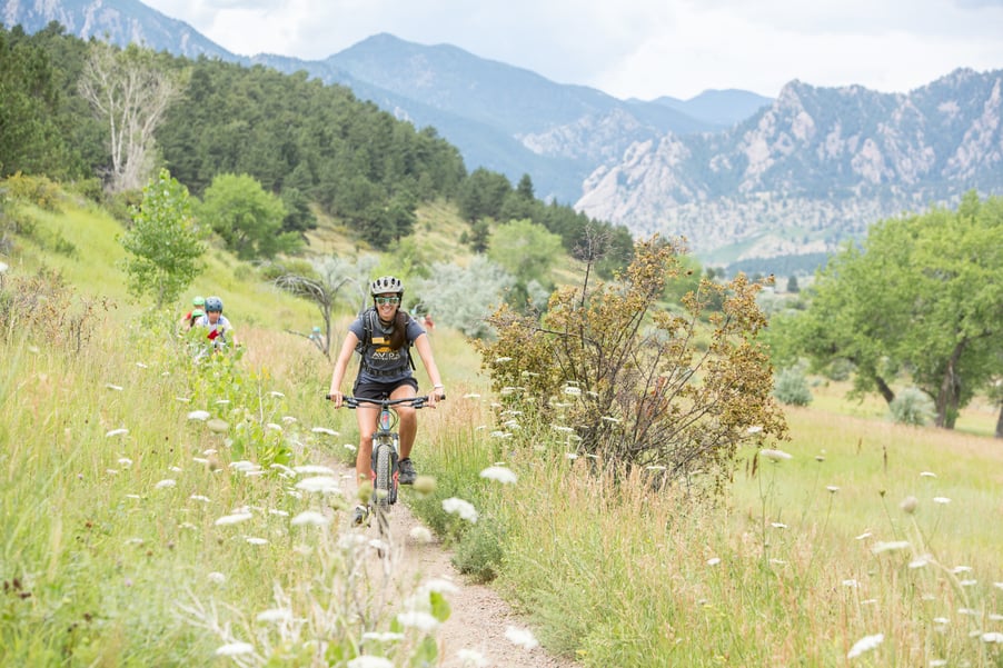 outdoor educator biking in boulder at summer camp